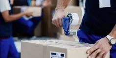 man taping box